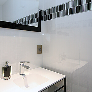 Small, newly remodeled bathroom with black and white theme
