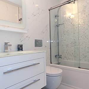 A bathroom with white cabinets
